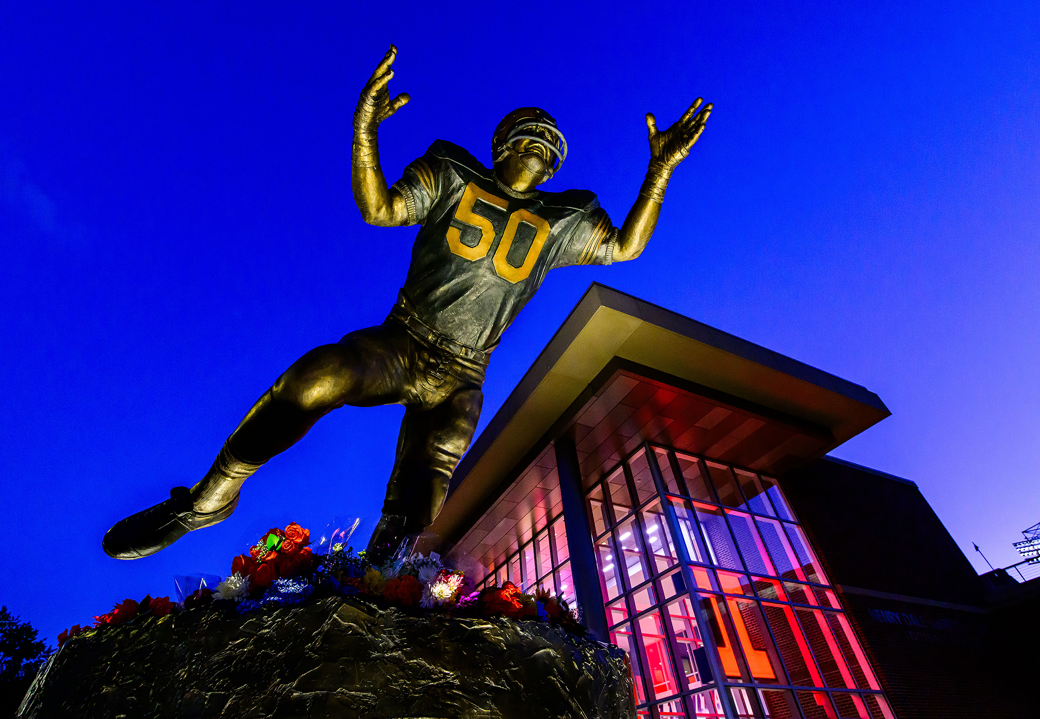 &amp;lt;em&amp;gt;Photo Credit: Fred Zwicky&amp;lt;br&amp;gt;&amp;lt;/em&amp;gt;&amp;lt;br&amp;gt;Fans of football great Dick Butkus, who gained his initial stardom as a linebacker great at the University of Illinois Urbana-Champaign, pay tribute after his passing by placing flowers and mementos at the feet of the bronze statue dedicated to the Illini linebacker great.