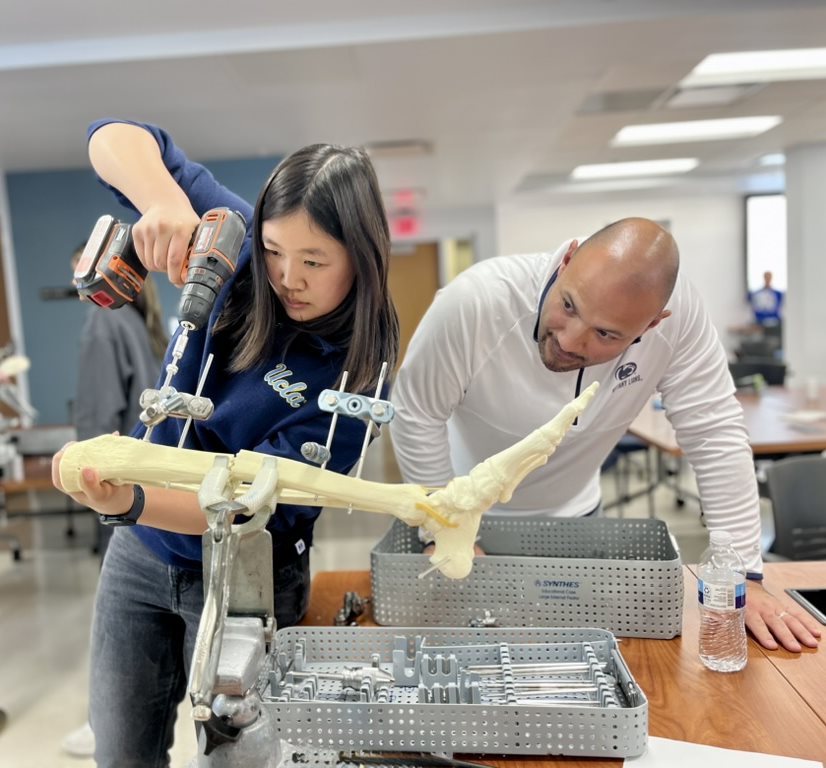 CI MED student Natalie Tsubamoto (left) practiced key skills in external fixation procedures to stabilize and repair lower extremity fractures. 