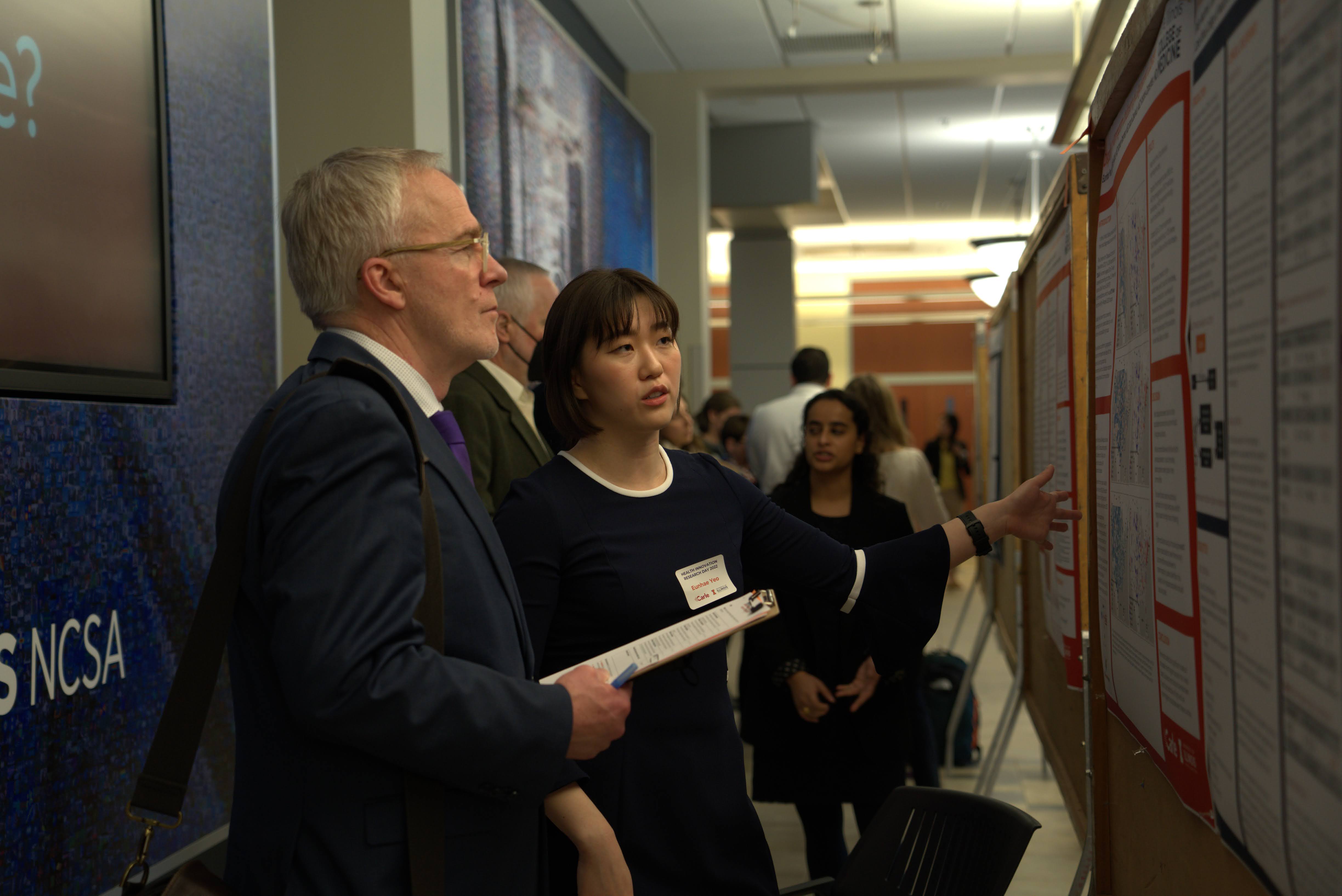Students presenting research at a poster session.