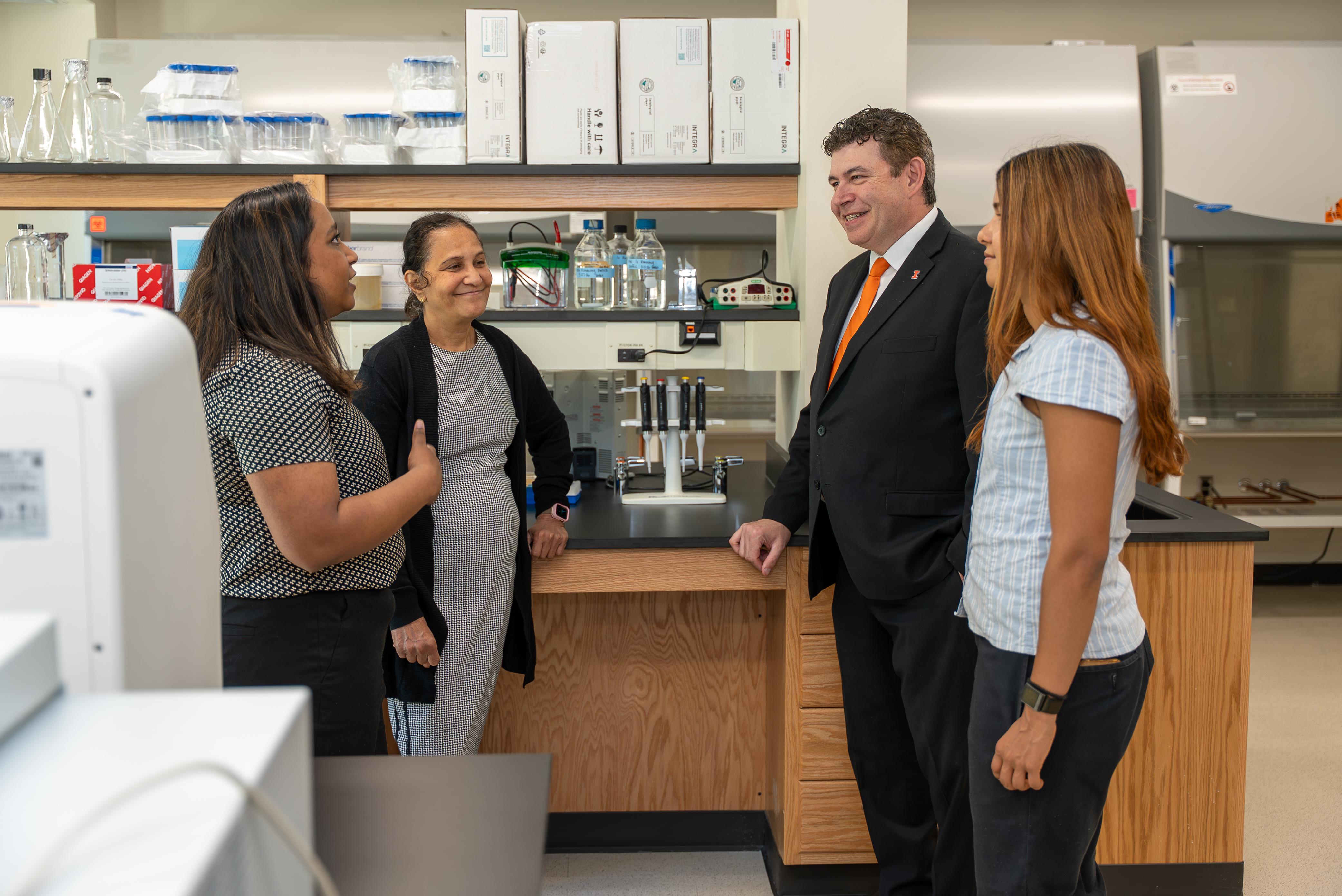 photo inside the Translational Oncology and Regenerative Medicine Laboratory with scientific equipment in the background and in the foreground from left to right, MD/PhD candidate&amp;Atilde;&amp;sbquo;&amp;Acirc;&amp;nbsp;Bhargavee Gnana,  Lab Director Chitra Subramanian, CI MED Dean Mark Cohen, and Bioengineering PhD candidate Navya Singh