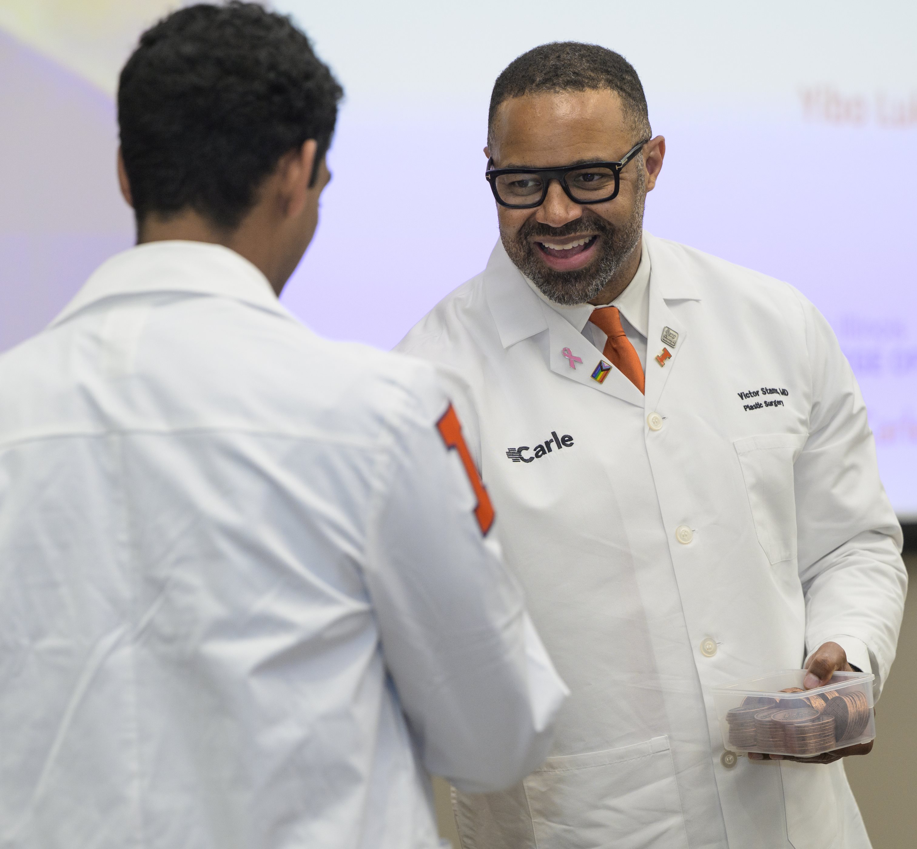 &amp;lt;em&amp;gt;Dr. Victor Stams (left) presented new class members with &amp;amp;nbsp;Healthmaker Coins, giving them access to innovation spaces on the&amp;amp;nbsp;U. of I.'s&amp;amp;nbsp;Urbana-Champaign campus.&amp;lt;/em&amp;gt;