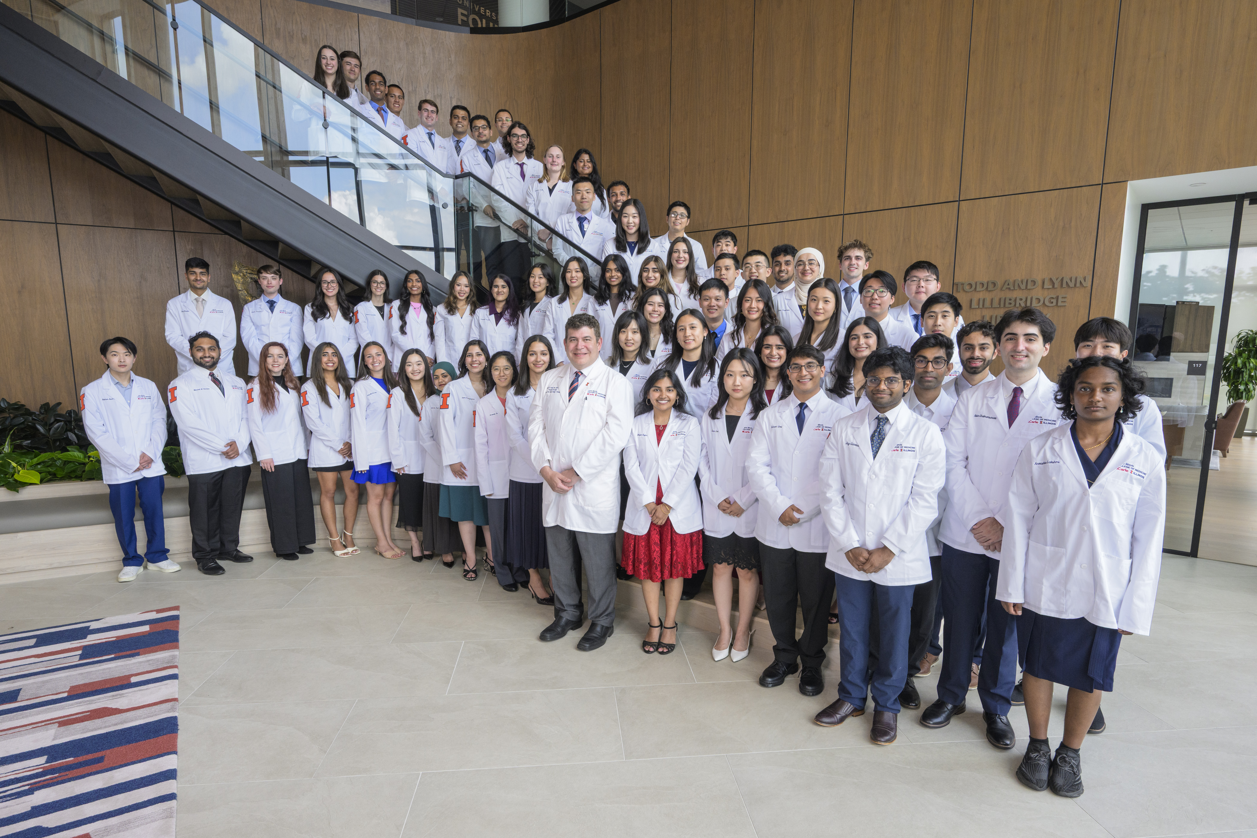 The members of the Carle Illinois College of Medicine Class of 2030 pose with Dean Mark Cohen (center, first row), at the I Hotel and Conference Center.