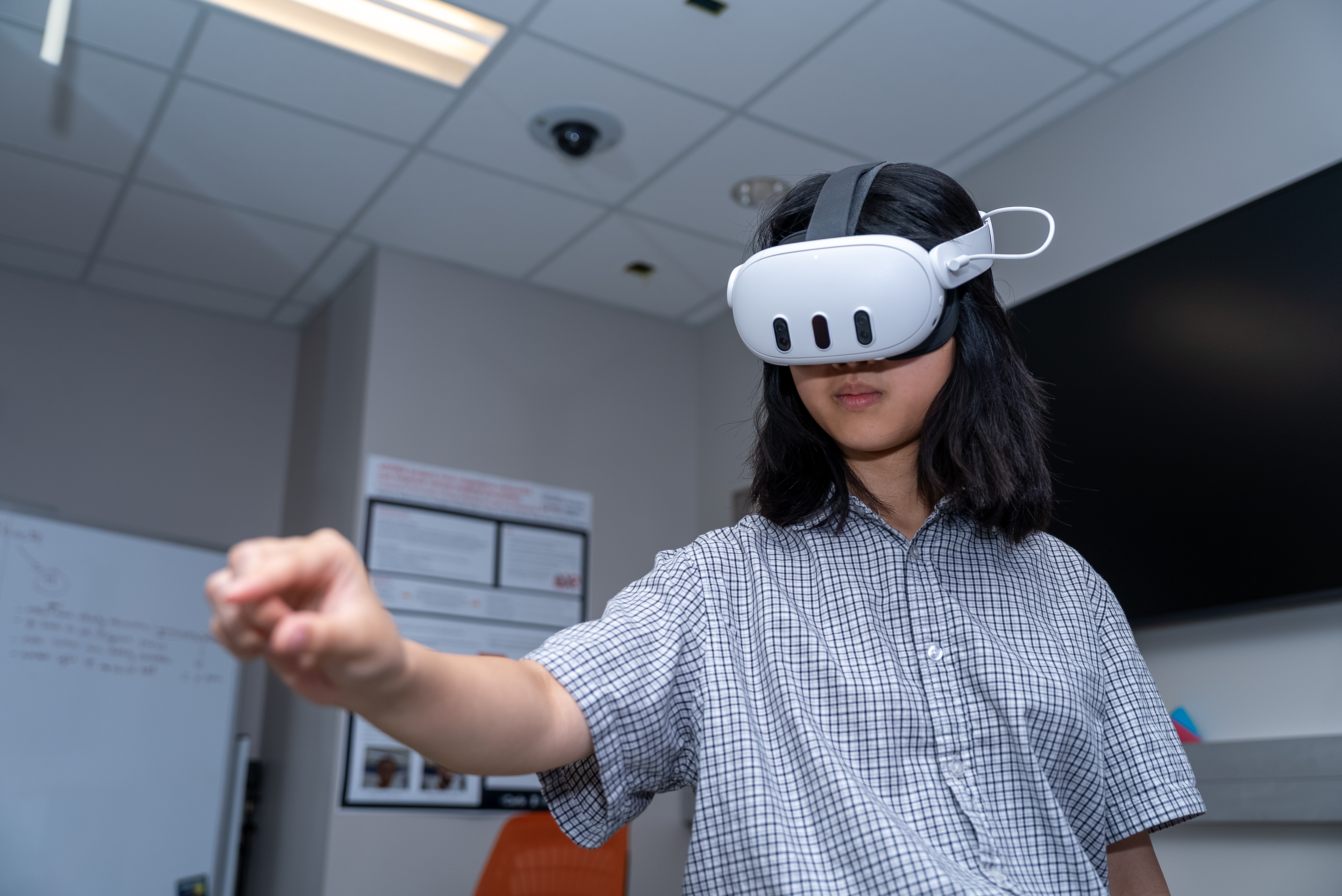 Kat Lin works with an XR headset at the Jump Simulation Center.