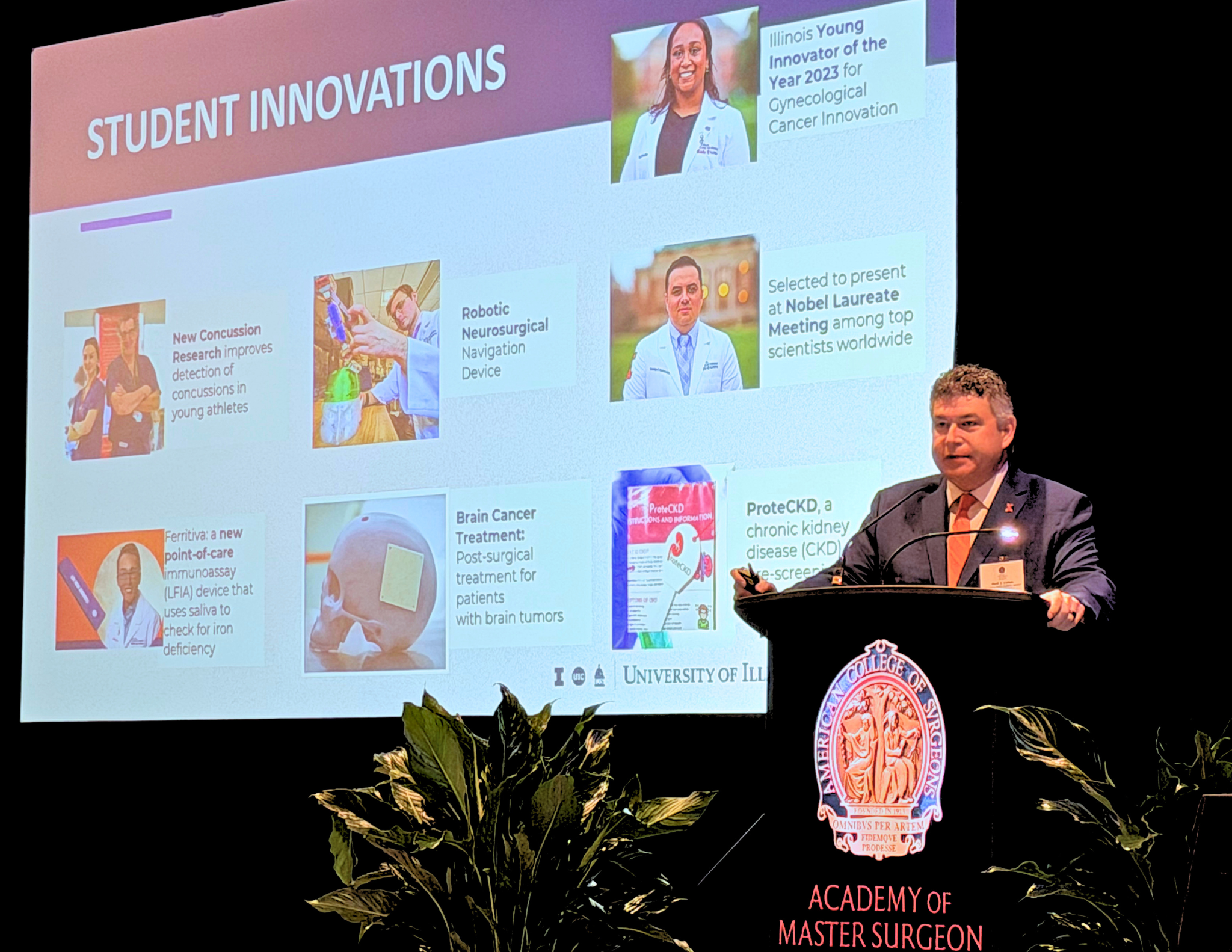 Dr. Mark Cohen stands at a podium during his keynote address to the Academy of Master Surgeon Educators&Acirc;&reg; Symposium in September 2026, in Chicago, with a PowerPoint slide in the background.