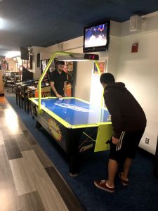 Two Carle Illinois students playing air hockey, Carle Illinois College of Medicine, University of Illinois at Urbana-Champaign