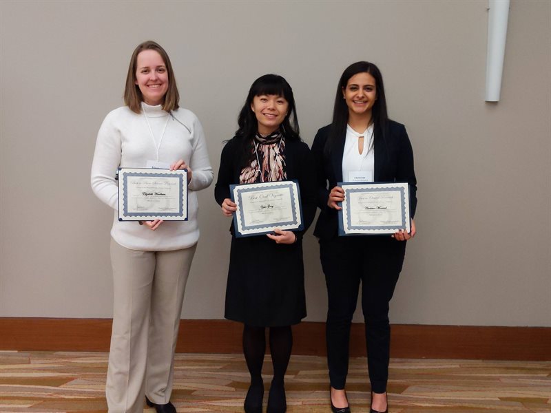 Carle Illinois students, Elizabeth Woodburn, Yusi Gong, and Christina Moawad, receiving their awards at the University of Illinois College of Medicine at Urbana-Champaign Research Day.