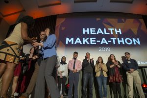 One Health Make-a-Thon winner, Sarah Nixon, receiving her Health Maker Lab coin.
