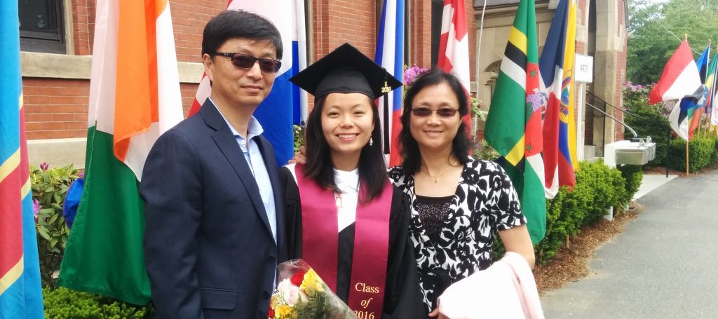 Yusi with her parents at her graduation from Tufts University.