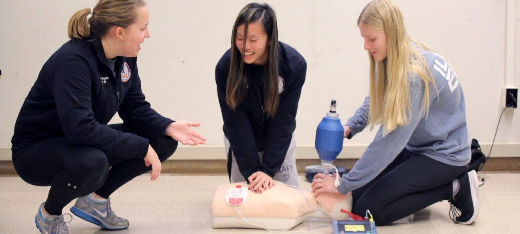 Elizabeth teaching CPR during her time with Illini Emergency Medical Services