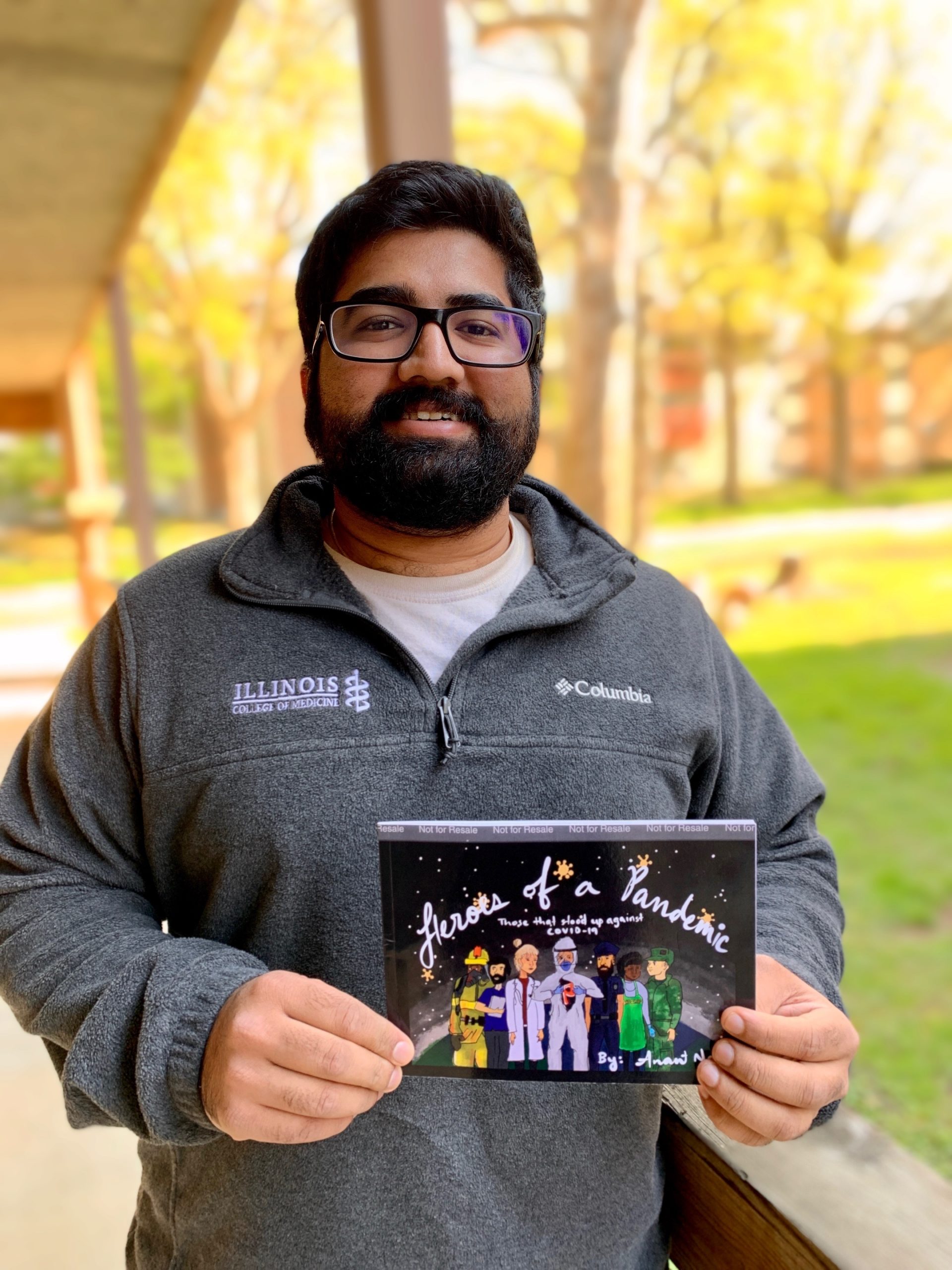 Anant Naik with his children's book, Heroes of a Pandemic