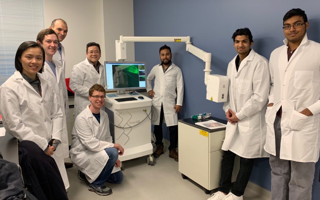 Illinois researchers with a prototype image-guided surgical system (standing third from left is Professor Viktor Gruev and fourth from left is Professor Shuming Nie).