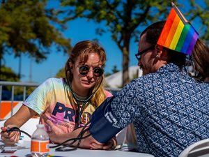 Sabrina Mann, a second year student, takes vital signs at the 2022 Urbana Pride Festival.