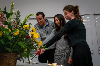 Hamad Linjawi, Peyton Paschell, and Claire Lee light a trio of candles in solidarity and remembrance for their donor family during the Cadaver Memorial Services for the Carle Illinois College of Medicine Class of 2025.