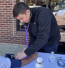 First-year medical student Modan Goldman performing blood pressure screenings for an Avicenna Outreach event at the Daily Bread Soup Kitchen.