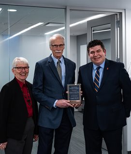 From left, Elizabeth Greeley, Carle Illinois College of Medicine Dean Mark Cohen and Dr. Don Greeley stand outside the newly named Donald A Greeley, MD &amp;amp; Elizabeth A. Greeley, PhD Problem-Based Learning Room in the Medical Sciences Building.
