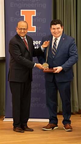 <em>Rashid Bashir, Dean of The Grainger College of Engineering, presents a medal to Dr. Mark Cohen, Founder Professor in&nbsp;Bioengineering.</em>