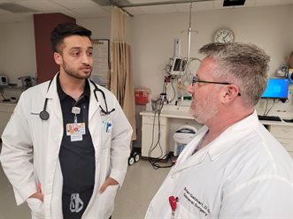 &lt;em&gt;Christopher Rouillard, left, a third-year medical student with Carle Illinois College of Medicine, meeting with Brian Gebhart, DO, a general surgeon, in the post-operative care unit of Carle BroMenn Medical Center in Normal.&lt;/em&gt;