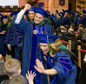 <em><strong>High-Fives and Fist Pumps</strong>: Morgan Lewis&nbsp;Ng (front), David&nbsp;Krist, and other members of the Class of 2024 celebrated their new title of 'medical doctor' at Convocation ceremonies on May 4, 2024.</em>